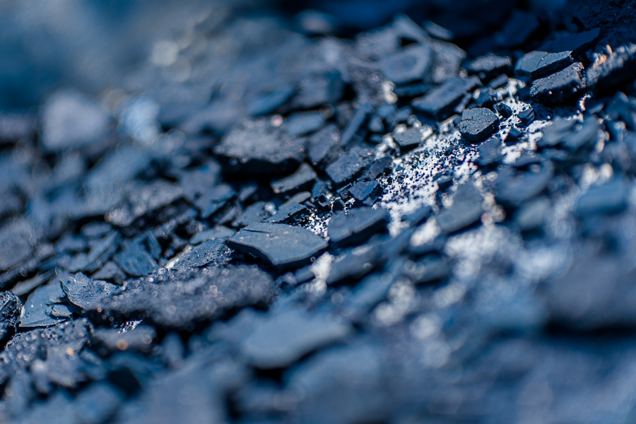 Cracked rocks of indigo paste, dried on the sun, are seen in the metal box at the semi-industrial manufacture near San Miguel, El Salvador.