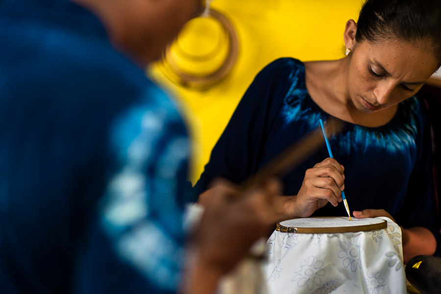 A Salvadoran woman draws the wax onto a white fabric, dyed with a natural blue indigo afterwards, in an artisanal clothing workshop in Santiago Nonualco, El Salvador.