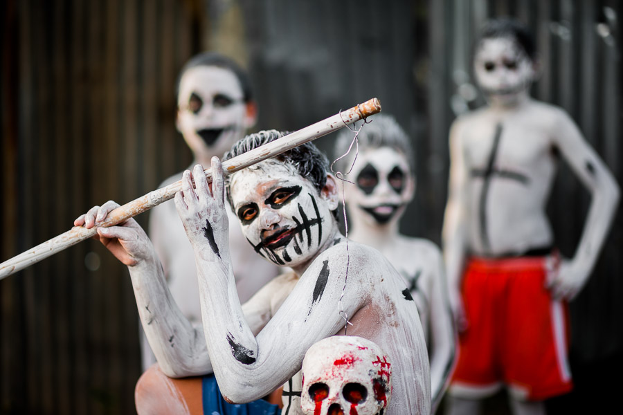 Salvadoran boys, having white body paint with death symbols, perform during the La Calabiuza parade at the Day of the Dead festivity in Tonacatepeque, El Salvador.