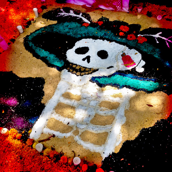 A female skeleton image made of sand, representing a Mexican cultural icon called La Calavera Catrina, forms a part of the public altar (ofrenda) seen on the street during the celebrations of the Day of the Dead (Día de Muertos) in Morelia, Michoacán, Mexico.