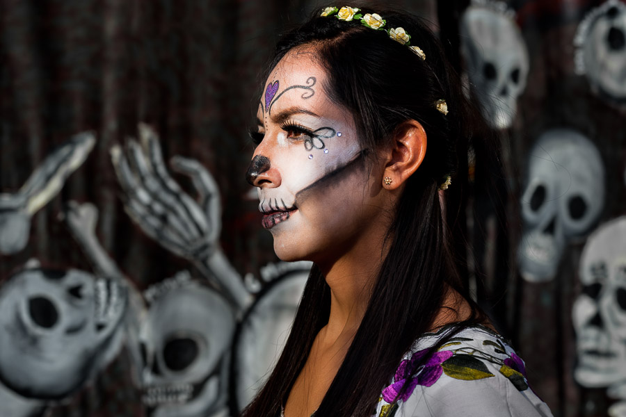 A young woman, dressed as La Catrina, a Mexican pop culture icon representing the Death, walks through the town during the Day of the Dead celebrations in Mexico City, Mexico.