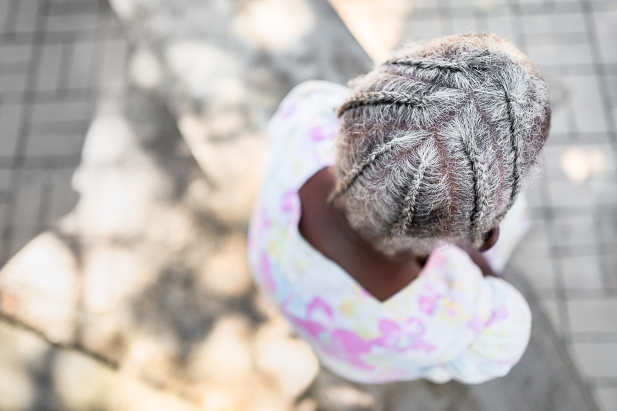 An old Afro-Colombian woman with white hair cornrows relaxes in a park in Quibdó, Chocó, Colombia.