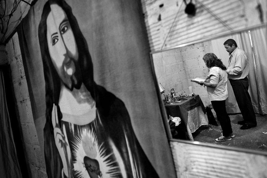 A Colombian female pastor reads bible before performing the religious healing ceremony at a house church in Bogota, Colombia.