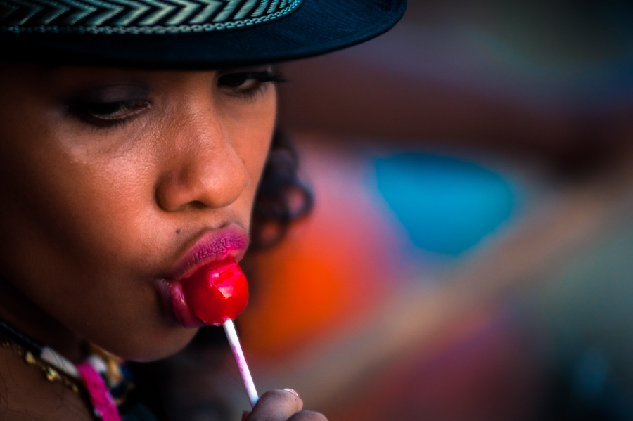 An Afro-Colombian girl sucks a lollipop while while watching the arena of Corralejas, a bullfighting festival on the Caribbean coast of Colombia.