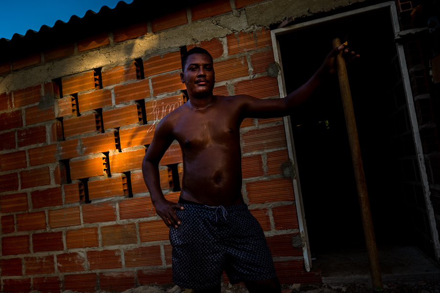 An Afro-Colombian man poses for a picture while building his house in Olaya Herrera, a lower social class neighborhood in Cartagena, Colombia.
