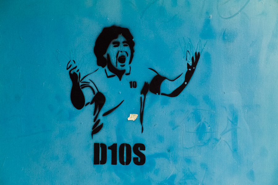 A spray and stencil artwork, depicting legendary Argentine football player Diego Maradona (D10S), appears on the street of San Jose, Costa Rica.