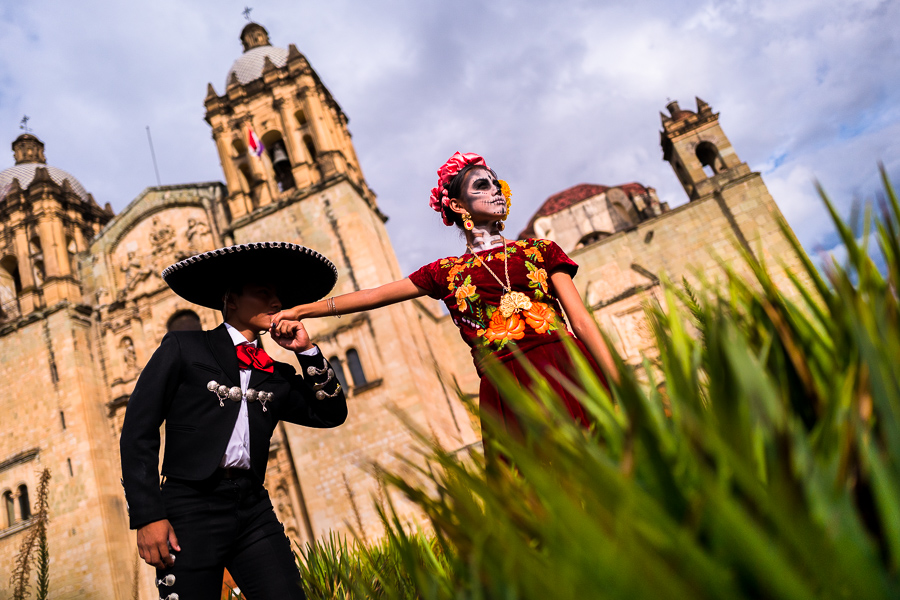 A young Mexican man, dressed as Mariachi, kisses a hand of a young Mexican woman, dressed as La Catrina, during the Day of the Dead festivities in Oaxaca, Mexico.