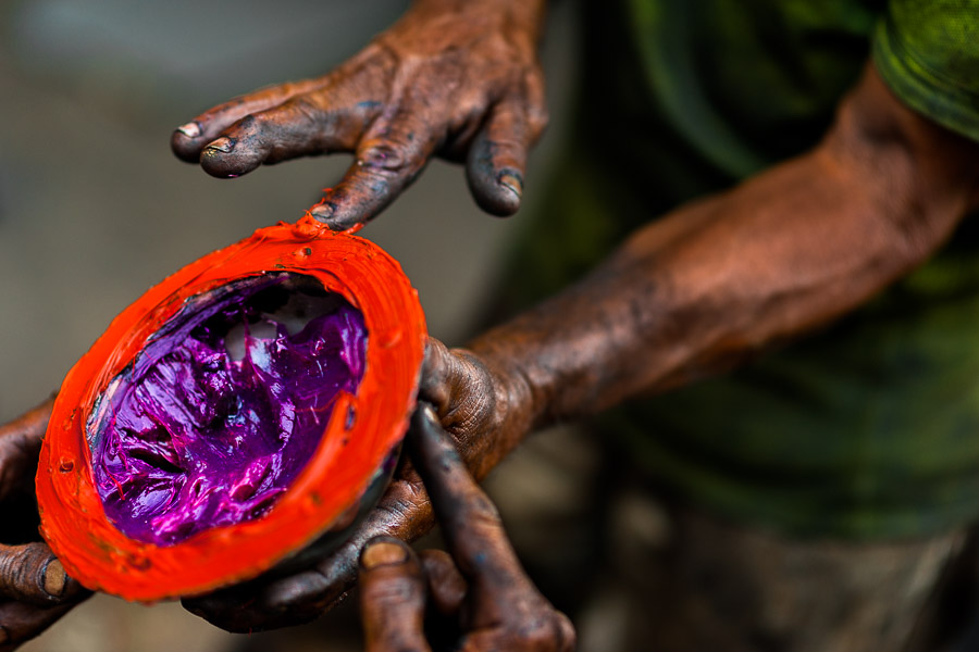 Colombian car mechanics apply different types of lubricant grease on a truck axle cap during the maintenance service in Barrio Triste, Medellín, Colombia.