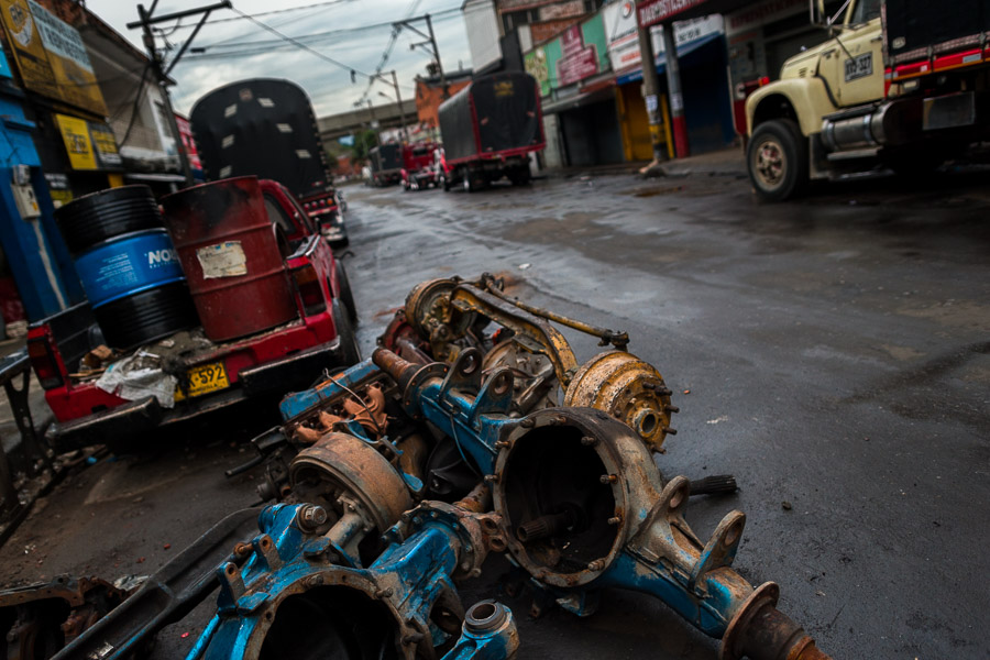 Truck rear axles are seen lying on the street of Barrio Triste, a car mechanics neighborhood in Medellín, Colombia.