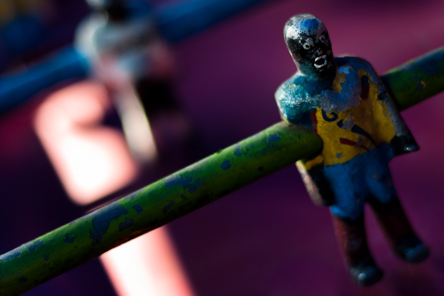 Table football player in yellow shirt, with peeled surface.