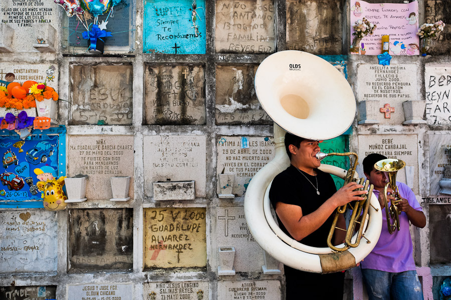 Mexican musicians play next to a columbarium during the Day of the Dead festivities in the cemetery of Morelia, Michoacán, Mexico.