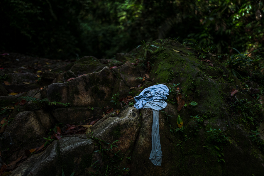A migrant's discarded clothing lies on a rock in the wild and dangerous jungle of the Darién Gap between Colombia and Panamá.