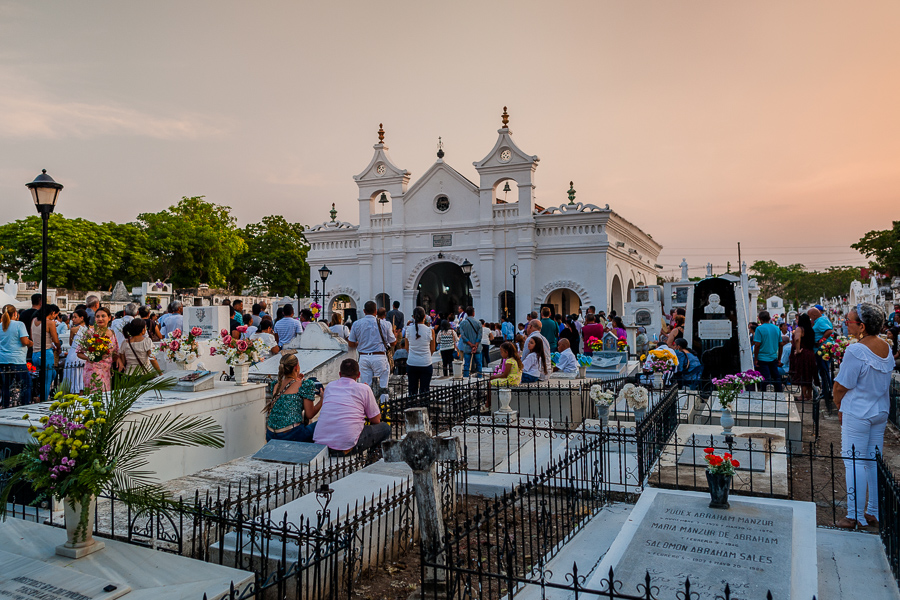 Colombians stand among tombs as they attend an evening mass during the Holy Week celebrations at the cemetery in Mompox, Colombia.