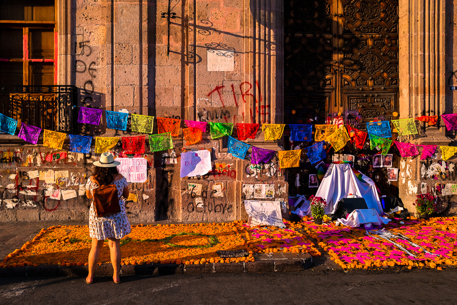 A Mexican woman watches the altar of the dead (Altar de Muertos), a religious site honoring the deceased, during the Day of the Dead festivities in Morelia, Michoacán, Mexico.