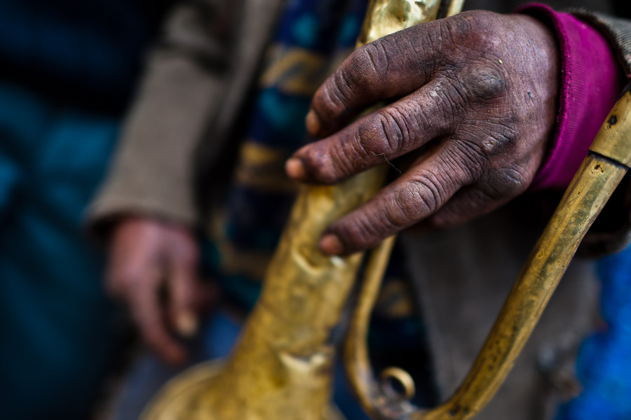 A Peruvian indigenous man holds a crumpled trumpet during the Yawar Fiesta, a ritual fight between the condor and the bull, held in the mountains of Apurímac, Peru.