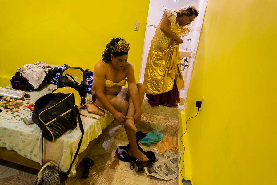 Mexican “muxes” (typically, homosexual men wearing female clothes) put on evening dresses while preparing for the night party during the Vela de las Intrépidas festival in Juchitán de Zaragoza, Oaxaca, Mexico.