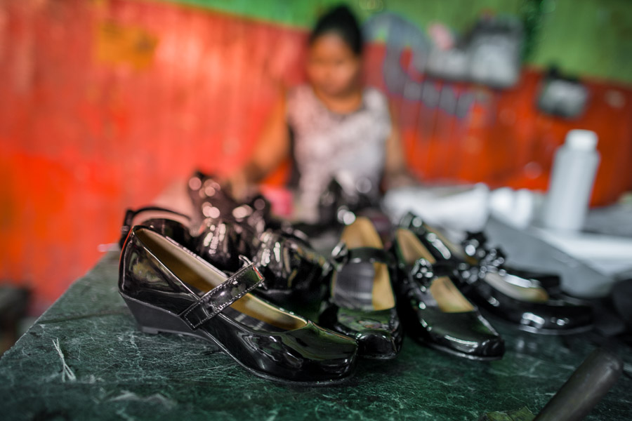 Newly made pairs of women’s patent leather shoes are seen placed on the table in a shoe making workshop in San Salvador, El Salvador.