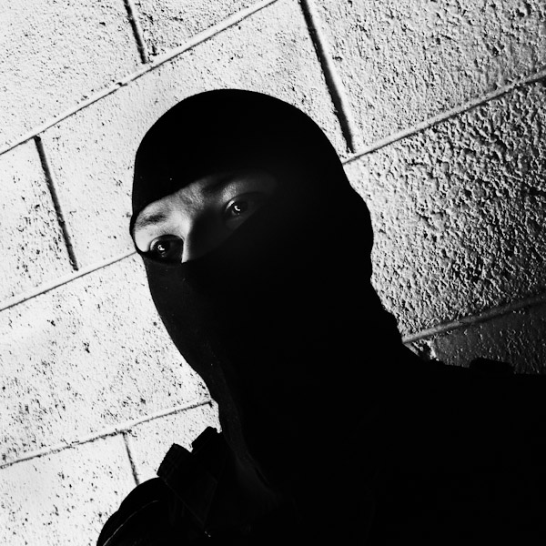 A member of the Police anti-gang unit, getting ready for an operation in the streets, stands on the base yard in San Salvador, El Salvador.