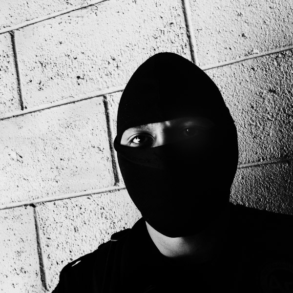 A member of the Police anti-gang unit, getting ready for an operation in the streets, stands on the base yard in San Salvador, El Salvador.