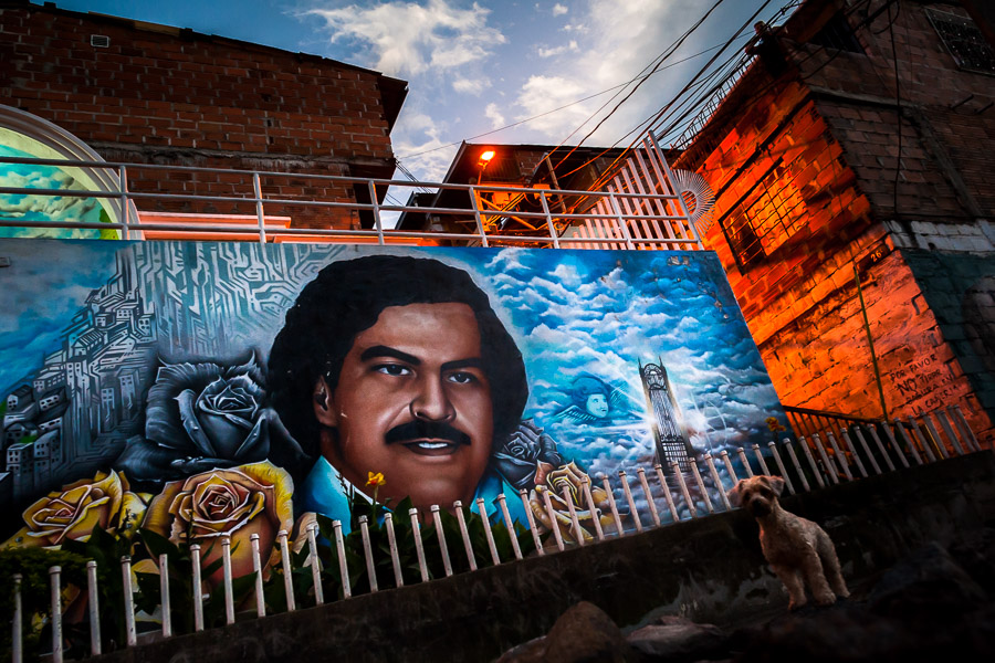 A large mural artwork, depicting the drug lord Pablo Escobar, is seen painted on the wall in the Pablo Escobar neighborhood in Medellín, Colombia.