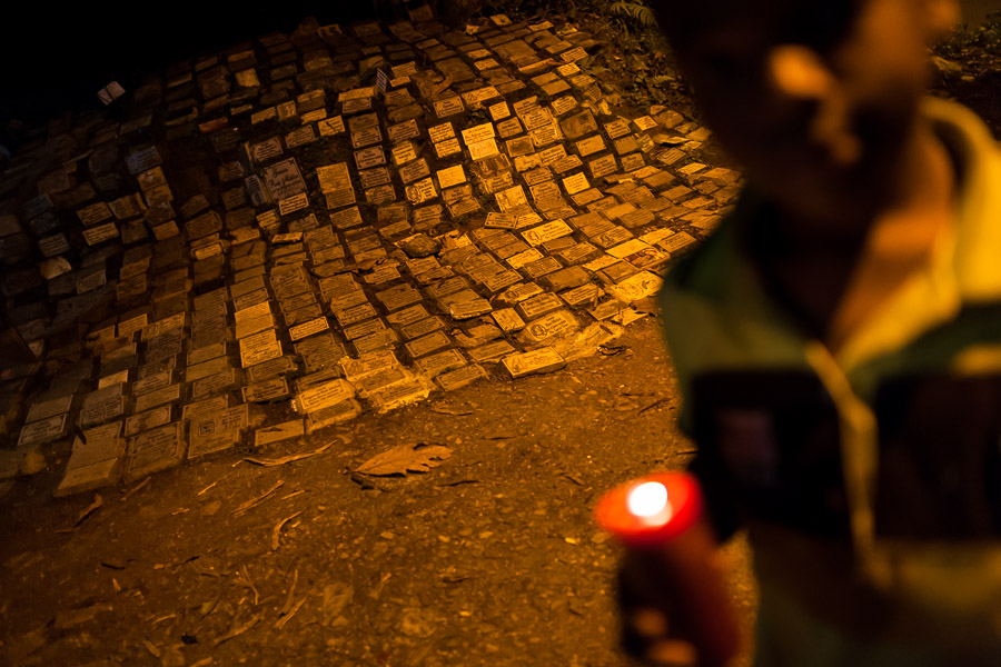 A Colombian boy holds a candle in front of the shrine of Virgin of Aguacatala, a saint worshipped by Pablo Escobar, in Medellin, Colombia.