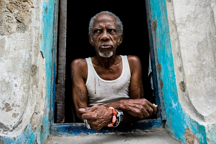 A Palo Monte priest looks out of the window in Havana, Cuba.