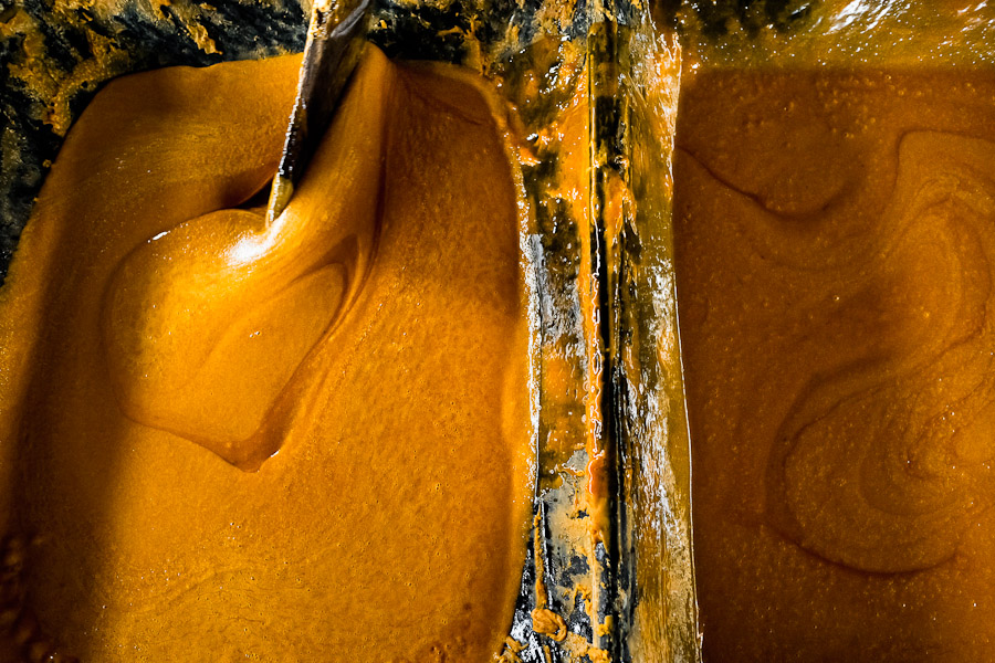 A hot mass of sugar cane juice seen during the processing of panela in a rural sugar cane mill in Valle del Cauca, Colombia.