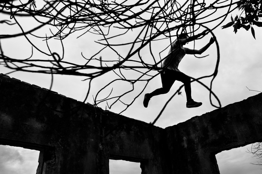 A freerunner from Plus Parkour team jumps on the top of ruined walls of an abandoned school in the outskirts of Bogotá, Colombia.