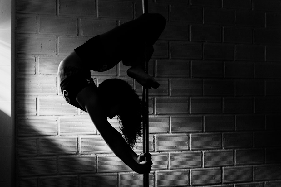 Carolina Echavarria, a young Colombian pole dancer, demontrates her flexibility during a pole dance training session in Academia Pin Up in Medellín, Colombia.