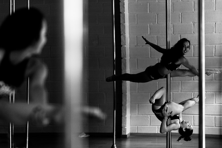 Carolina Echavarria and Valeria Aboultaif, young Colombian pole dancers, perform during a pole dance training session in Academia Pin Up in Medellín, Colombia.