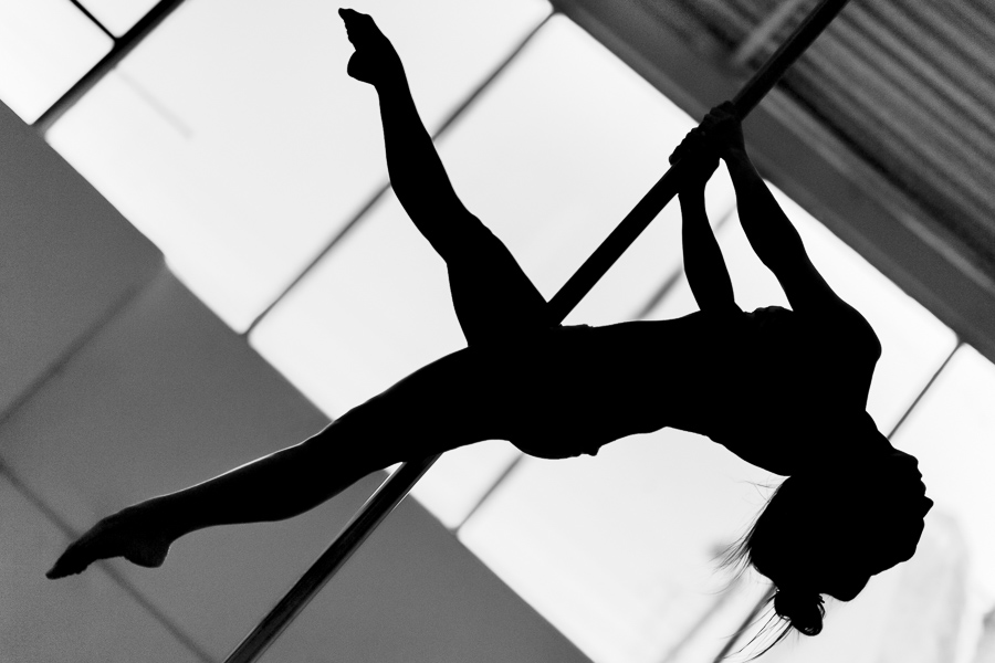 A young Colombian pole dancer performs a dance routine during a pole dance training session in a gym in Bogotá, Colombia.