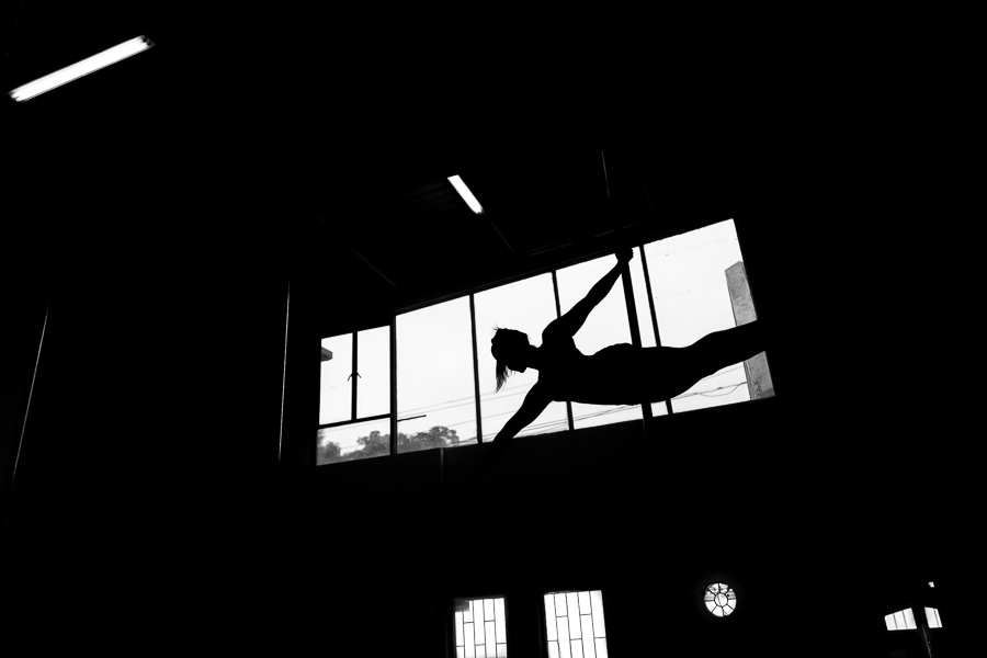 A young Colombian pole dancer performs a dance routine during a pole dance training session in a gym in Bogotá, Colombia.