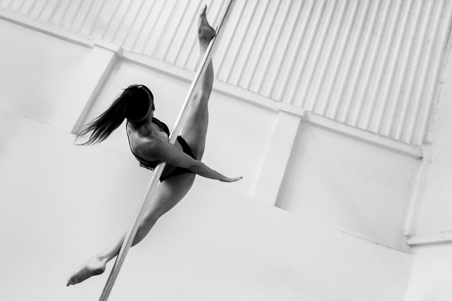 A young Colombian pole dancer performs a dance routine during a pole dance training session in a gym in Bogotá, Colombia.