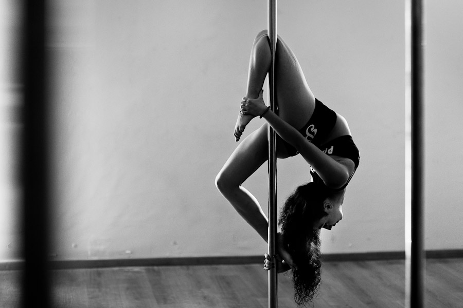 Carolina Echavarria, a young Colombian pole dancer, demontrates her gymnastics during a pole dance training session in Academia Pin Up in Medellín, Colombia.