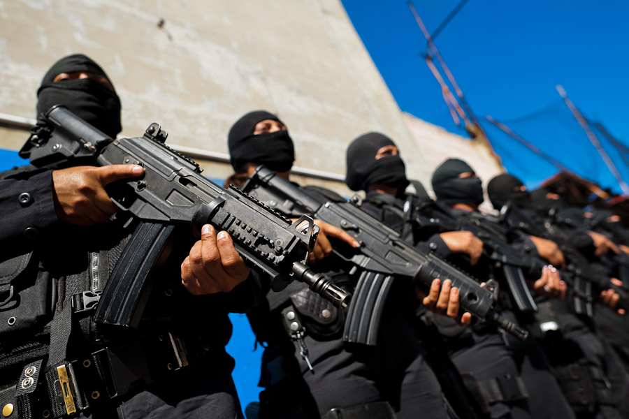 Salvadorean policemen, members of the specialized anti-gang unit, stand on the police base before leaving for an operation in San Salvador, El Salvador.
