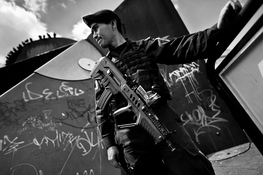 A young Colombian policeman, armed with the Israeli TAR-21 assault rifle, guards in the center of Bogota, Colombia.