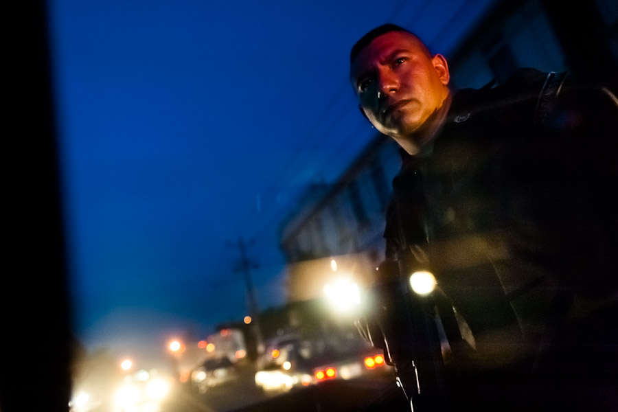 A policeman from the special emergency unit (Halcones) watches the street from a driving vehicle in San Salvador, El Salvador.