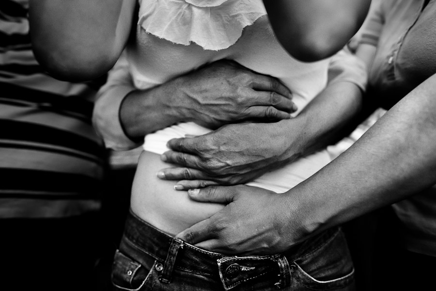 A Colombian girl is seen held tightly by missionaries during the exorcism ritual performed at a house church in Bogota, Colombia.