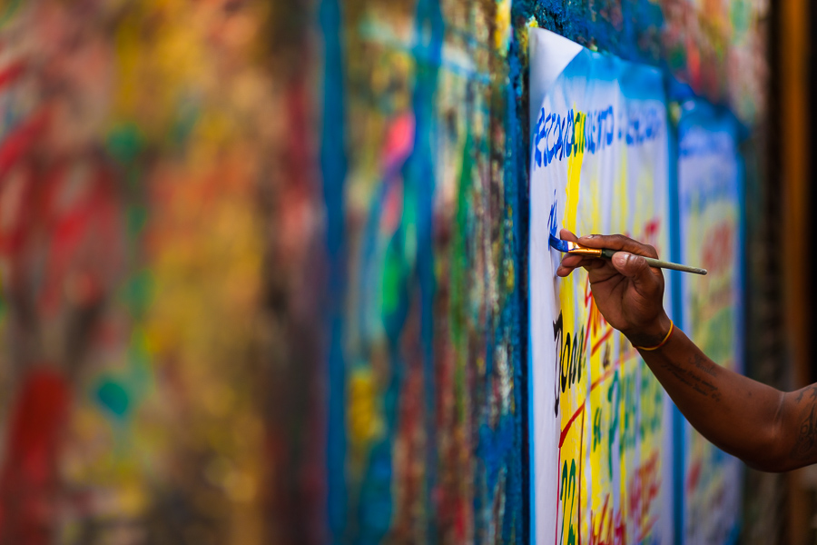 A Colombian sign painter’s hand is seen writing with a brush on a music party poster in the sign painting workshop in Cartagena, Colombia.