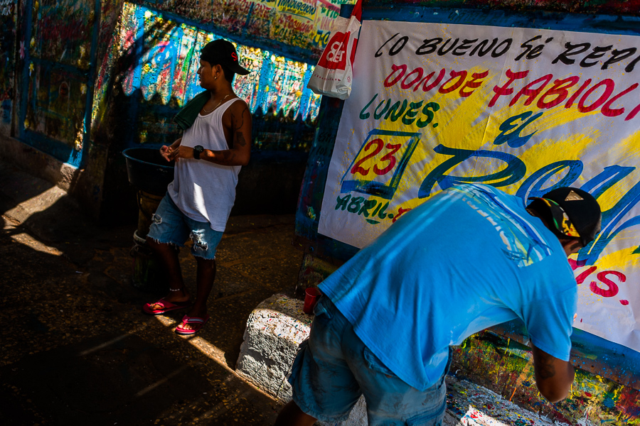 Colombian sign painters work on a large music party poster in the sign painting workshop in Cartagena, Colombia.