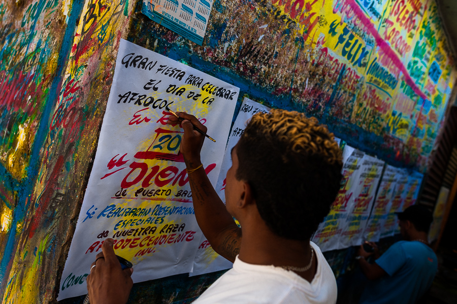 A Colombian sign painter writes with a brush while working on music party posters in the sign painting workshop in Cartagena, Colombia.
