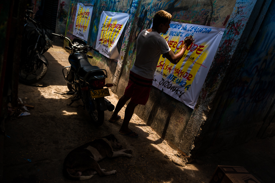 A Colombian sign painter writes with a brush while working on music party posters in the sign painting workshop in Cartagena, Colombia.