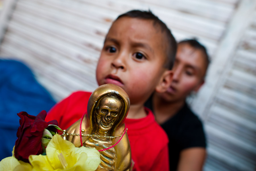 On the first day of every month, devotees to Santa Muerte fill the streets of Tepito, holding figurines of Holy Death and praying at the altar established in a window at the home of Enriqueta Romero.