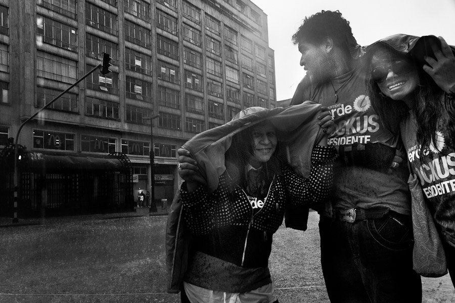 Young Colombians caught in the rain in the center of Bogota, Colombia.
