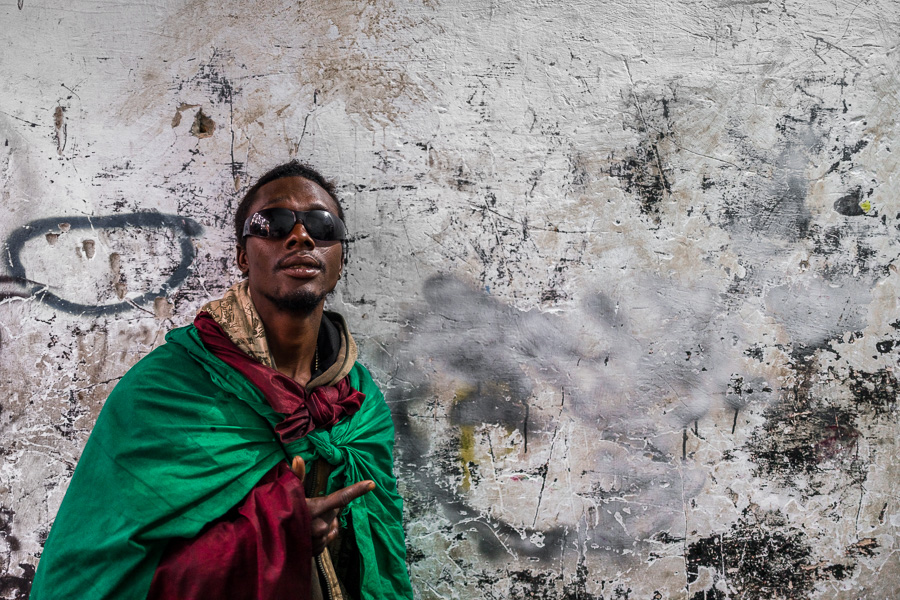 A Colombian drug consumer poses for a picture while unloading a street-collected waste in a recycling warehouse in Medellín, Colombia.