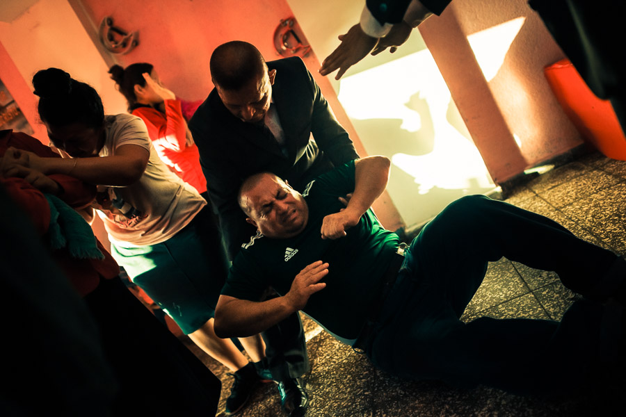 A Christian follower, a member of a local religious cult, falls to the ground during the religious trance in a home church in San Salvador, El Salvador.