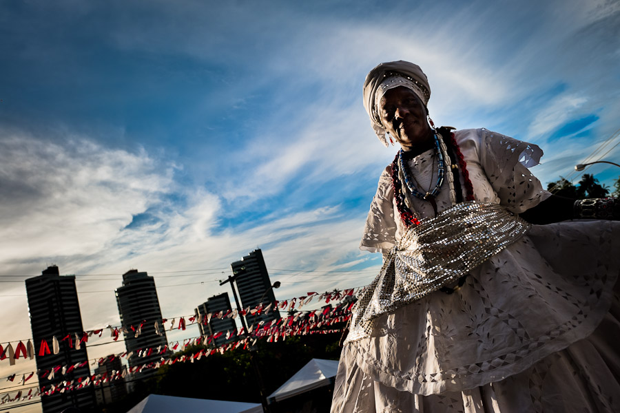 A Baiana woman climbs the stairs, before the ritual dance in honor to Omolú, the Candomblé spirit syncretized with Saint Lazarus, in front of the St. Lazarus church in Salvador, Bahia, Brazil.