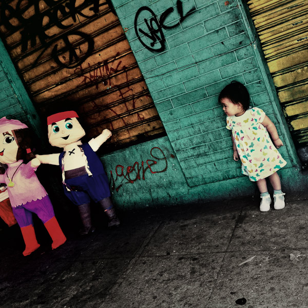 A little Salvadorean girl looks at the paper dolls sold for the child birthday festivities in San Salvador, El Salvador