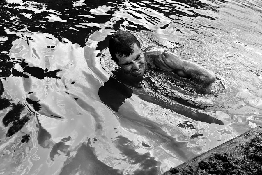 A sand miner, diving under the water, extracts sand from the bottom of the river La Vieja in Cartago, Colombia.