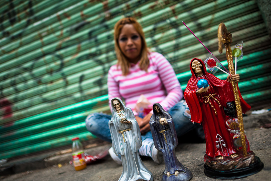 Santa Muerte usually appears as a skeletal figure covered most often in a white, black or red robe and carrying a scythe and a globe.